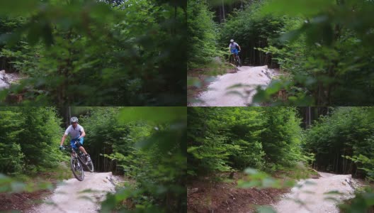 年轻的山地自行车手在森林里骑着山道下坡高清在线视频素材下载