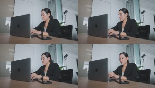 女商人使用笔记本电脑在家庭办公室的办公桌高清在线视频素材下载