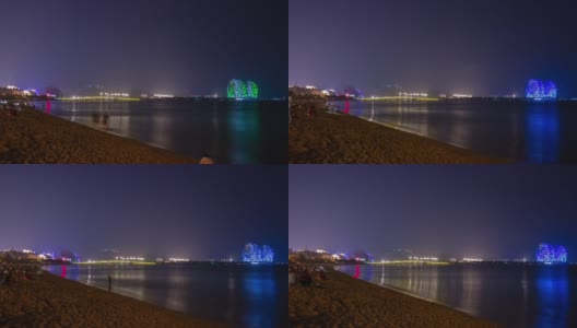 夜光璀璨的三亚拥挤的海滩著名的酒店全景4k时间推移海南岛中国高清在线视频素材下载