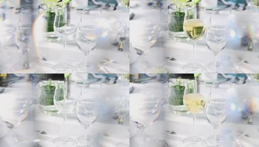 在水晶窗帘后面的精致餐桌上倒白葡萄酒高清在线视频素材下载