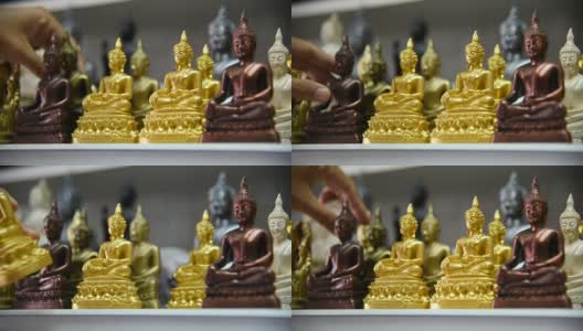 一名泰国游客在纪念品商店选购佛像。高清在线视频素材下载