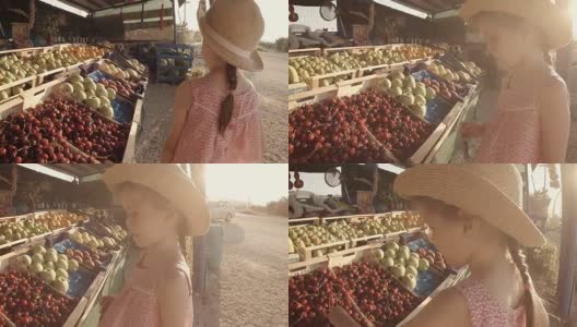 小女孩在农贸市场挑选水果高清在线视频素材下载