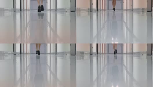 一个穿着黑色高跟鞋的女人走在办公楼的走廊上高清在线视频素材下载