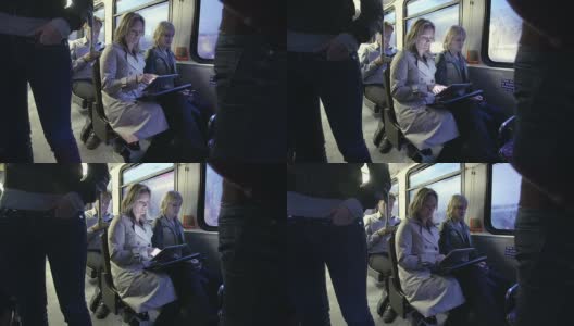 在公交车上玩平板电脑的通勤者高清在线视频素材下载