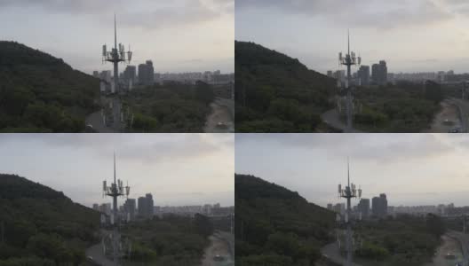 日落时分，城市立交桥旁的5G信号塔高清在线视频素材下载