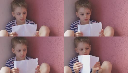 男孩在纸上读课文高清在线视频素材下载