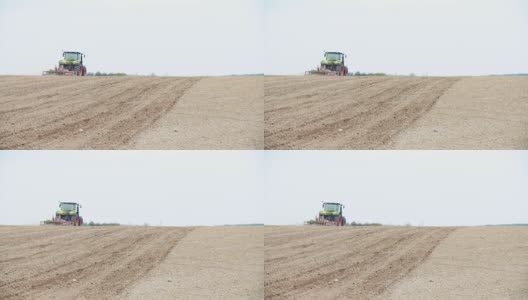 拖拉机在田间工作的宽拍摄。高清在线视频素材下载