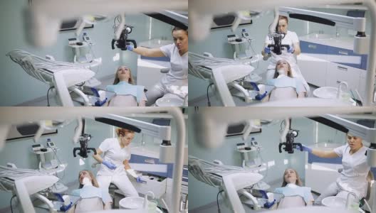 女牙医使用牙科工具-显微镜，镜子和探针在牙科诊所治疗病人的牙齿。医学、牙科和保健概念。牙科设备高清在线视频素材下载