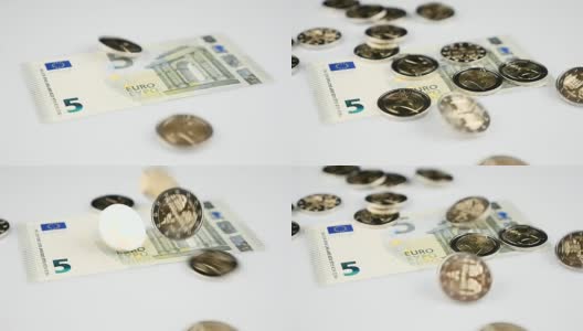 两枚欧元硬币落在钞票上高清在线视频素材下载