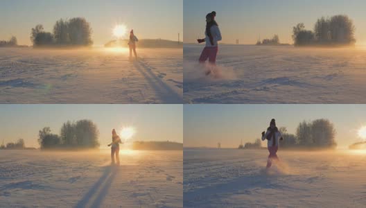 女人在冬天跑过田野，踢着雪在日落时飞着雪花高清在线视频素材下载