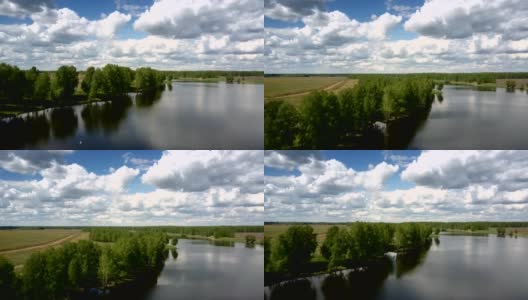 美丽的蓝色河流在森林的岸边，靠近无尽的田野高清在线视频素材下载