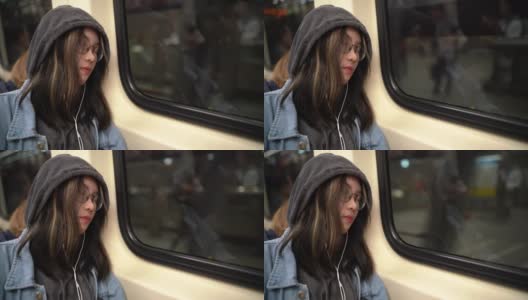 一个年轻的亚洲女人睡在地铁里高清在线视频素材下载