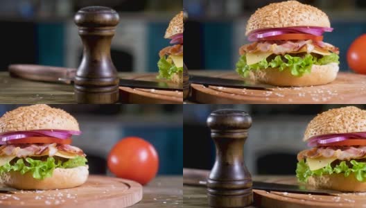汉堡包的全景图片与黑胡椒瓶在厨房的背景。高清在线视频素材下载