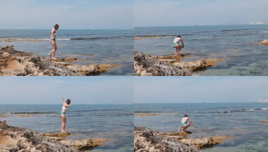 年轻的白人褐发女人在她的腿上的脂肪团沿着岩石海滩的海岸走高清在线视频素材下载