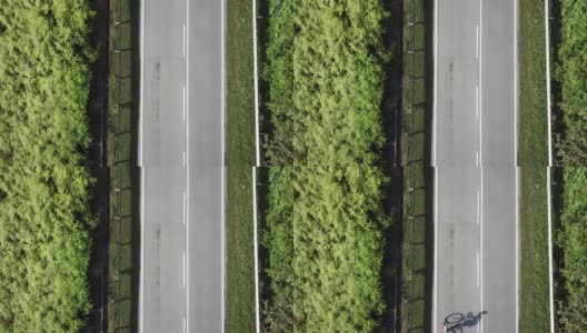 在乌鲁兰加农村地区骑自行车公路旅行与2名女运动员在早上无人机的观点高清在线视频素材下载