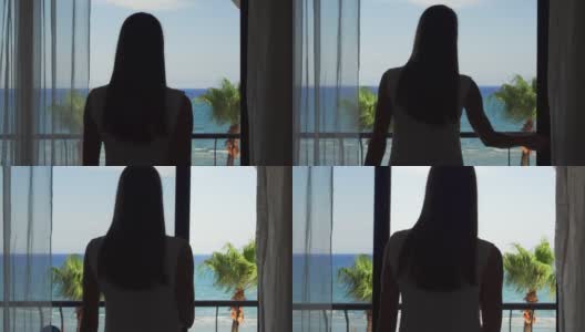 女士打开阳台滑动玻璃门，从阳台上欣赏地中海海景高清在线视频素材下载