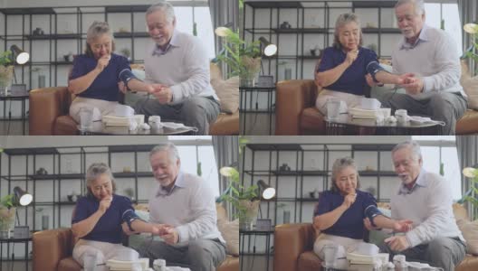 祖父手用数码测量血压在家里用便携式设备为祖母检查，亚洲夫妇在家里检查血压。高清在线视频素材下载