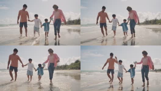 一家人一起在海滩上散步高清在线视频素材下载