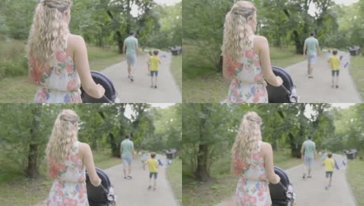 一家人在一个阳光明媚的日子里在公园里散步高清在线视频素材下载