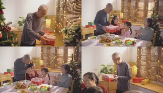 亚洲家庭一起赠送礼物礼盒，同时晚餐和庆祝圣诞假期在公寓高清在线视频素材下载