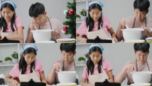 圣诞节期间，亚洲孩子们在家里拍摄饼干烹饪视频制作病毒视频，或者在家里一起拍TikTok，这是新一代概念的时尚生活方式。高清在线视频素材下载