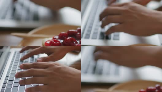 人类的双手在笔记本电脑键盘上打字，木制的桌子上有在家工作的元素，多莉拍摄倾斜高清在线视频素材下载