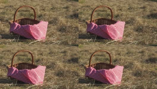 复古野餐篮和红色格子布毯子拍摄在农村的田野高清在线视频素材下载