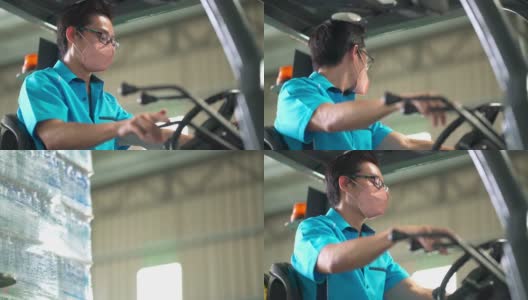 亚洲华人男性仓库工人，带着口罩在工业工厂操作叉车高清在线视频素材下载