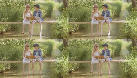 一个男孩和一个女孩坐在人行桥上看书高清在线视频素材下载