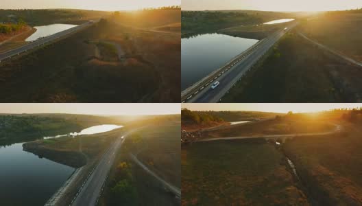 重型卡车在风景如画的牧场和湖泊之间的公路上行驶高清在线视频素材下载