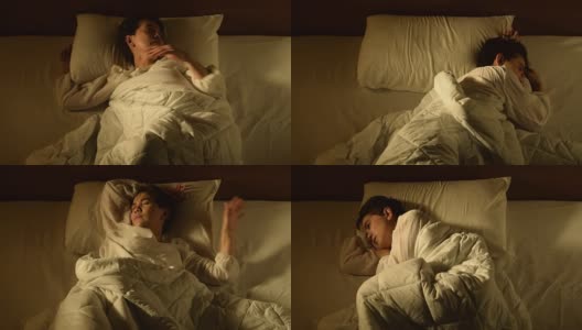 一名抑郁的女子因失眠躺在床上高清在线视频素材下载