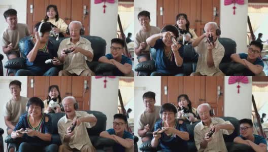 2名亚裔中国祖父母在家里和孙辈玩电子游戏。高清在线视频素材下载