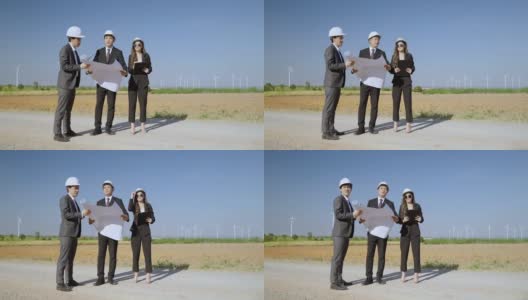 检查员和一名工程师以及一名秘书正在检查一个风力发电机发电领域的项目。清洁能源理念，可再生能源，拯救世界。高清在线视频素材下载