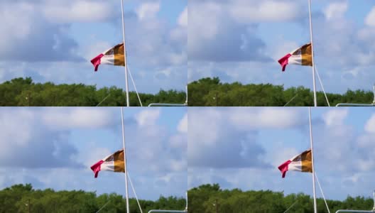 墨西哥美丽的Holbox岛上挂着一面绿白红的国旗。高清在线视频素材下载