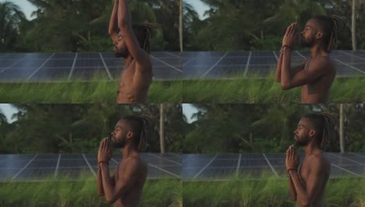 黑人男子做高温瑜伽合十礼式屋顶太阳能电池快速慢动作高清在线视频素材下载