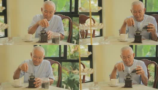 亚洲老人拿着老式咖啡机高清在线视频素材下载