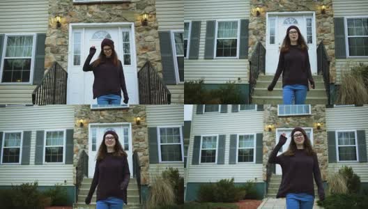 一个十几岁的女孩站在社区的房子前高清在线视频素材下载