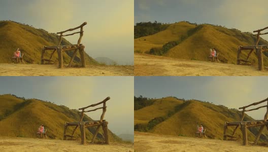 淘金:黎明时分，大山后面的旧木椅高清在线视频素材下载