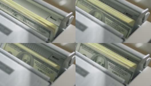 机器计数器自动计算大量的美元钞票在慢动作180fps高清在线视频素材下载