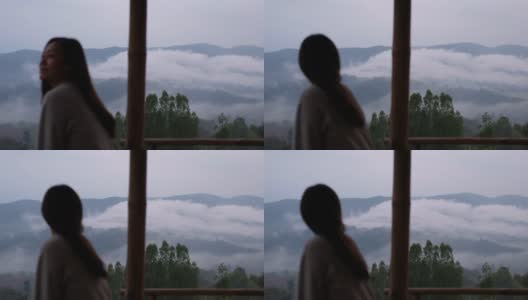 模糊的一个女人坐在看美丽的山景在雾天高清在线视频素材下载