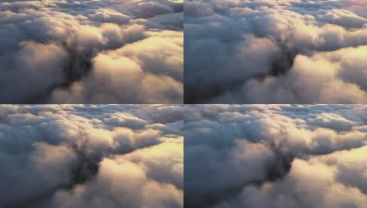 高空鸟瞰图，远处的城市被傍晚暴雨前形成的蓬松的积云所覆盖。飞机角度多云的景观高清在线视频素材下载