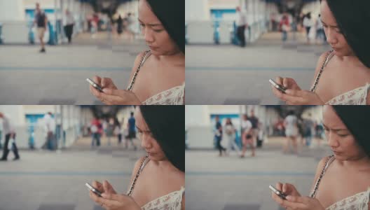 女性在城市场景中用智能手机搜索媒体高清在线视频素材下载