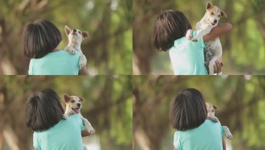 亚洲小女孩和小狗在花园里高清在线视频素材下载