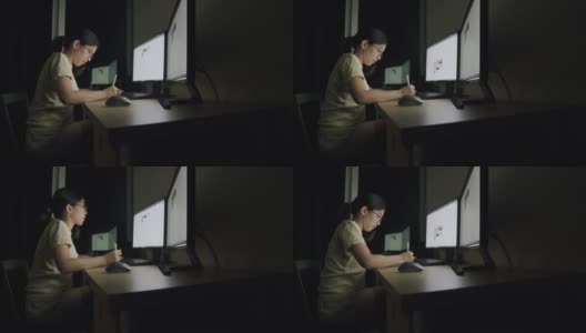 亚洲女商人Candid晚上在家庭办公室用平板电脑写作。高清在线视频素材下载