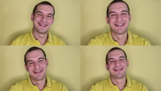 在黄色背景上，一个白人男子微笑着竖起大拇指的肖像高清在线视频素材下载