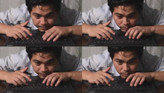 一个年轻人晚上在家里用电脑工作高清在线视频素材下载