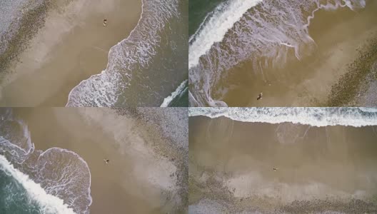 一个少女走在蒙托克角的海岸上。航拍镜头，正上方的景色。高清在线视频素材下载