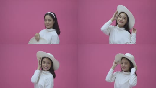 快乐的年轻女子亚洲微笑，有很好的时间，笑，戴着帽子看在粉红色的背景高清在线视频素材下载