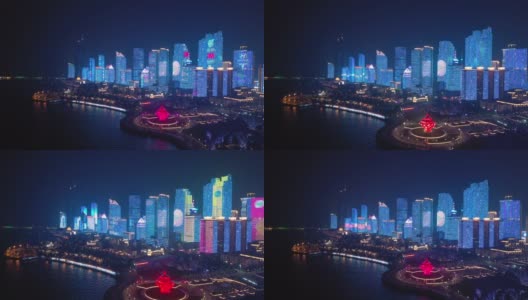夜间照明展示青岛市区著名的4k中国海湾广场航拍全景高清在线视频素材下载