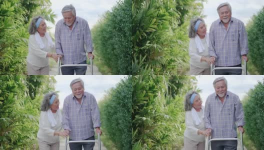 年老的亚洲妻子照顾她生病的丈夫使用帮助学习在房子周围的花园散步。老年保健与健康保险的概念高清在线视频素材下载